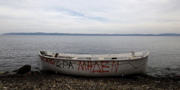A wooden boat, used by migrants and refugees, is abandoned at a beach on the Greek island of Lesbos November, 2015. The writing on the boat reads