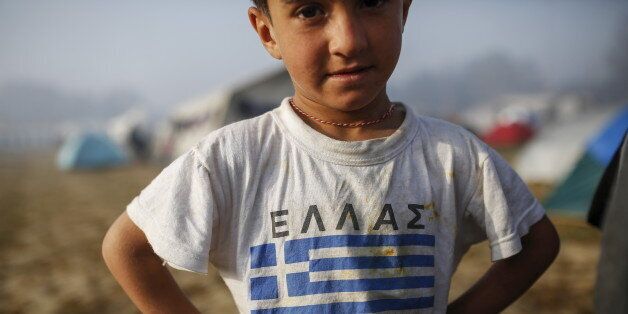 A child wearing a t-shirt with Greek flag stands at a makeshift camp for migrants and refugees at the Greek-Macedonian border near the village of Idomeni, Greece, April 5, 2016. REUTERS/Marko Djurica