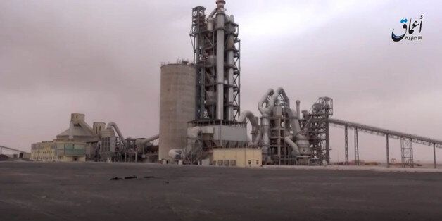 This image made from video published online by Amaq News Agency of the Islamic State group shows a cement factory where in a brazen assault near the Syrian capital, Islamic State militants snatched up to 300 cement workers and contractors from their workplace northeast of Damascus Thursday, April 7, 2016. (militant video via AP)