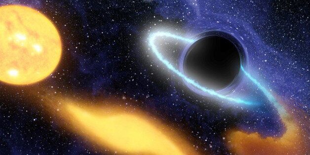 Supermassive black hole at the center of a remote galaxy digesting the remnants of a star. (Photo by Universal History Archive/UIG via Getty Images)