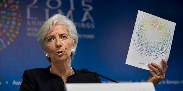 International Monetary Fund chief Christine Lagarde holds up a folder labeled Global Policy Agenda during a press conference, in Lima, Peru, Thursday, Oct. 8, 2015. The world's finance ministers and central bankers are in Lima for the joint annual meetings of the World Bank and IMF that run through Sunday. (AP Photo/Rodrigo Abd)
