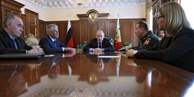 Russian President Vladimir Putin (C) meets with Interior Minister Vladimir Kolokoltsev (2ndL), Russia's Drug Control Service Chief Viktor Ivanov (L), Interior Ministry Troops Commander in Chief, Army Gen. Viktor Zolotov (2ndR) and an official of the Federal Migration Service at the Kremlin in Moscow on April 5, 2016. Russian President Vladimir Putin on April 5 announced the creation of a national guard tasked with fighting terrorism and organised crime, a move analysts said could be aimed at warding off unrest over the country's economic crisis. / AFP / SPUTNIK / MIKHAIL KLIMENTYEV (Photo credit should read MIKHAIL KLIMENTYEV/AFP/Getty Images)