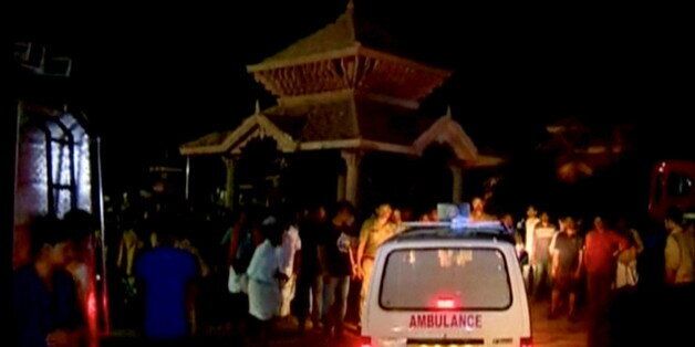 An ambulance is seen next to people after a fire broke out as people gathered for a fireworks display at a temple in Kollam, southern India, in this still image taken from video April 10, 2016. REUTERS/ANI via REUTERS TV ATTENTION EDITORS - THIS PICTURE WAS PROVIDED BY A THIRD PARTY. REUTERS IS UNABLE TO INDEPENDENTLY VERIFY THE AUTHENTICITY, CONTENT, LOCATION OR DATE OF THIS IMAGE. EDITORIAL USE ONLY. NOT FOR SALE FOR MARKETING OR ADVERTISING CAMPAIGNS. NO RESALES. NO ARCHIVE. THIS PICTURE IS DISTRIBUTED EXACTLY AS RECEIVED BY REUTERS, AS A SERVICE TO CLIENTS. NO ACCESS BBC. FOR REUTERS CUSTOMERS ONLY.