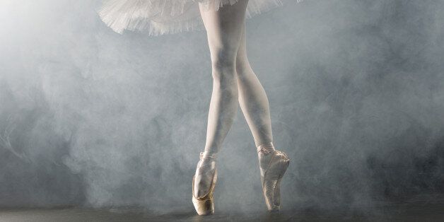 'Young female ballerina standing on toes, low section'