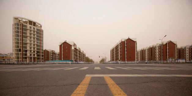 Residential apartment buildings stand in the new district of Kangbashi in Ordos, Inner Mongolia, China, on Friday, April 29, 2011. Designed for 300,000 people, Kangbashi, the new urban center of Ordos prefecture, may have only 28,000 residents, Bank of America-Merrill Lynch said last year. Photographer: Nelson Ching/Bloomberg via Getty Images