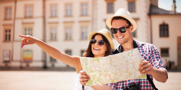 Happy tourist sightseeing city with map