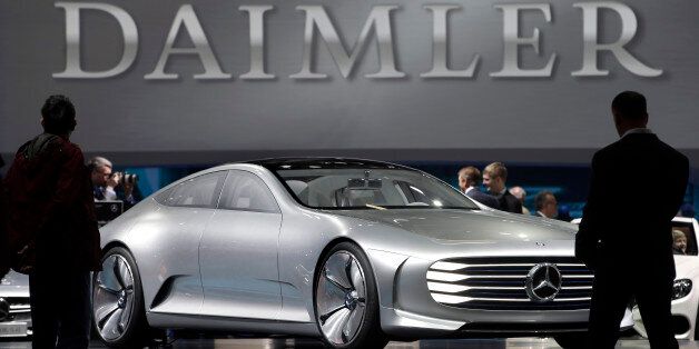 Visitors look at a Mercedes Benz concept car prior to the shareholders meeting of the Daimler AG in Berlin, Germany, Wednesday, April 6, 2016. (AP Photo/Michael Sohn)