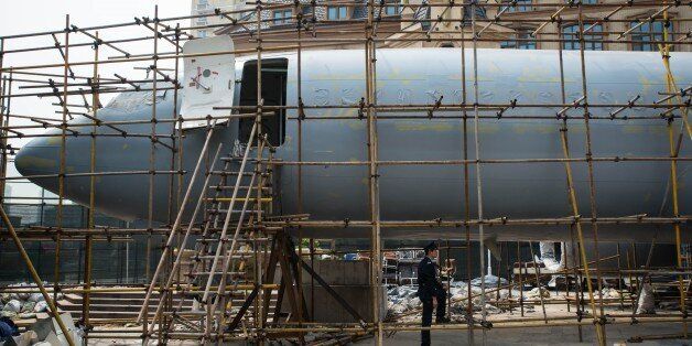 WUHAN,CHINA - MARCH 22: A construction works are seen inside the Boeing 737 plane which is converting into a restaurant at Optics Valley square in Wuhan, China on March 22, 2016. Boeing 737-4Y0 aircraft fuselage has about 33 meters lenght, with a wingspan of up to 28.9 meters and it can accommodate more than 120 people. (Photo by Zhong Zhenbin/Anadolu Agency/Getty Images)