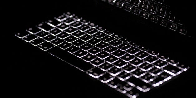 Backlit keyboard is reflected in screen of Apple Macbook Pro notebook computer in Warsaw February 6, 2012. REUTERS/Kacper Pempel (POLAND - Tags: BUSINESS)