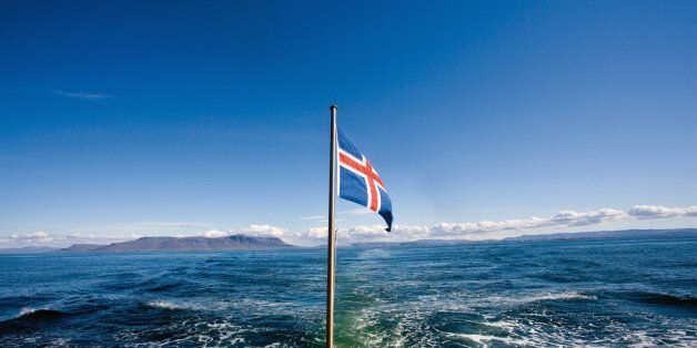 Icelandic flag with sea in background