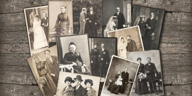 group of vintage family and wedding photos circa 1890-1920. nostalgic sentimental pictures on rustic wooden background