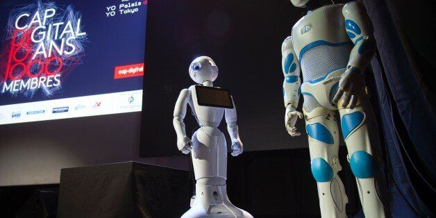 Aldebaran Robotics' robots are displayed on stage during the 10th anniversary of Cap Digital, the French business cluster for digital transformation, at the Palais de Tokyo in Paris on March 24, 2016. / AFP / LIONEL BONAVENTURE (Photo credit should read LIONEL BONAVENTURE/AFP/Getty Images)