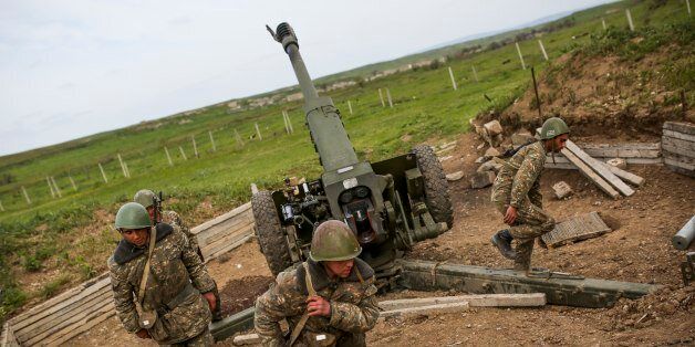 Nagorno-Karabakh army artillerymen prepare to open fire from a howitzer on positions in Nagorno-Karabakh, Azerbaijan, Tuesday, April 5, 2016. Azerbaijan forces and separatist forces in Nagorno-Karabakh agreed on a cease-fire Tuesday following three days of the heaviest fighting in the region since 1994, the Azeri defense ministry announced. (Vahan Stepanyan/PAN Photo via AP)