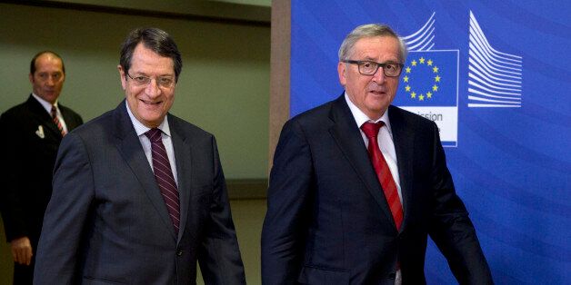 European Commission President Jean-Claude Juncker, right, walks with Cypriot President Nicos Anastasiades prior to a meeting at EU headquarters in Brussels on Wednesday, March 16, 2016. The Cypriot president is in Brussels on Wednesday to meet with EU leaders prior to a summit on migration which begins Thursday. (AP Photo/Virginia Mayo)