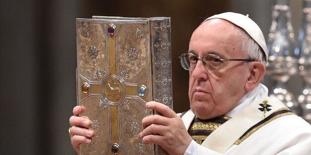 Pope Francis holds the book of the gospels during the Chrism Mass for Holy Thursday on March 24, 2016 at St Peter's basilica in Vatican. AFP PHOTO / TIZIANA FABI / AFP / TIZIANA FABI (Photo credit should read TIZIANA FABI/AFP/Getty Images)