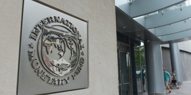 The seal of the International Monetary Fund is seen on a headquarters building in Washington, DC on July 5, 2015. The euro was dropping against the dollar after early results of the Greece bailout referendum suggested the country rejected fresh austerity demands from EU-IMF creditors. AFP PHOTO/MANDEL NGAN (Photo credit should read MANDEL NGAN/AFP/Getty Images)