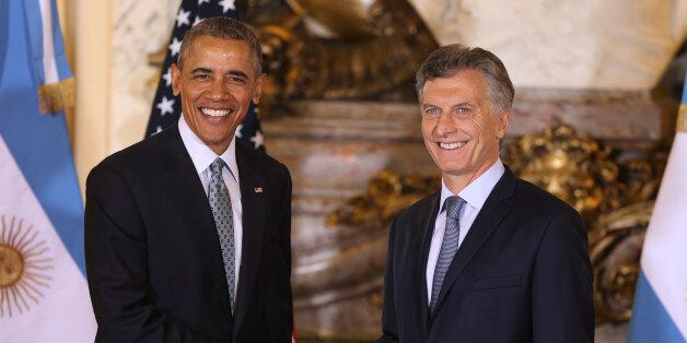 U.S. President Barack Obama shakes hands with Argentina's President Mauricio Macri at the government house in Buenos Aires, Argentina, Wednesday, March 23, 2016. Obama is on a two day official visit to Argentina. (David Fernandez/Pool Photo via AP)