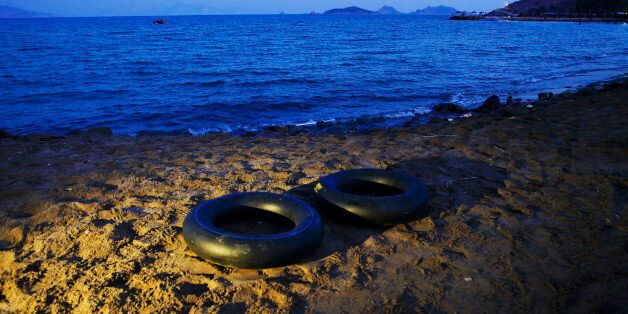 Rubber rings, used by migrants to try to cross on dinghies to the nearby Greek island of Kos, are seen abandoned on a beach near the coastal town of Bodrum, Turkey, early Tuesday, Aug. 18, 2015. Six migrants drowned off the Turkish coast early Tuesday as they tried to reach the Greek islands, a rescuer said, underscoring the deadly risks taken by migrants making even short crossings to Europe in overcrowded smugglersâ boats. (AP Photo/Lefteris Pitarakis)