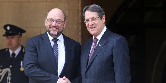 European Parliament President Martin Schultz, left, and Cyprus' President Nicos Anastasiades shake hands before their meeting at the presidential palace in capital Nicosia, Cyprus, Tuesday, March 29, 2016. Schultz is in Cyprus for two days official visit. (AP Photo/Philippos Christou)