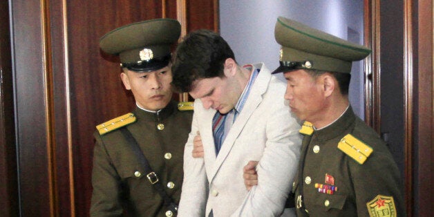 American student Otto Warmbier, center, is escorted at the Supreme Court in Pyongyang, North Korea, Wednesday, March 16, 2016. North Korea's highest court sentenced Warmbier, a 21-year-old University of Virginia undergraduate student, from Wyoming, Ohio, to 15 years in prison with hard labor on Wednesday for subversion. He allegedly attempted to steal a propaganda banner from a restricted area of his hotel at the request of an acquaintance who wanted to hang it in her church. (AP Photo/Jon Chol Jin)