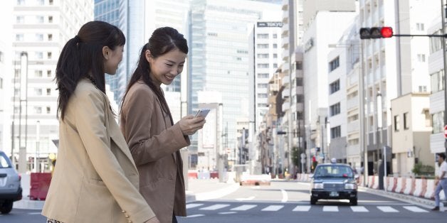 Two businesspeople outdoors walking in office town