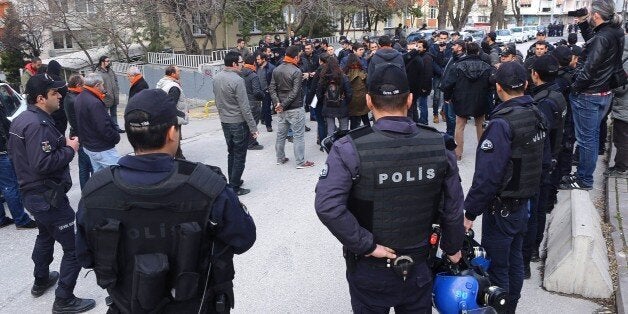 Turkish police officers circle left wing partisans as they demonstrate against Turkish government and make a statement to the press after having been forbidden to gather in a protest march in Ankara, on March 20, 2016. / AFP / ADEM ALTAN (Photo credit should read ADEM ALTAN/AFP/Getty Images)