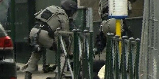 ADDING IDENTITY OF MAN IS CONFIRMED TO BE SALAH ABDESALAM - In this framegrab taken from VTM, armed police officers lift Salah Abdeslam to a police vehicle during a raid in the Molenbeek neighborhood of Brussels, Belgium, Friday March 18, 2016. The identity of Salah Abdeslam is confirmed Saturday March 19, 2016, by French police and deputy mayor of Molenbeek, Ahmed El Khannouss quoting official Belgium police sources. After an intense four-month manhunt across Europe and beyond, police on Friday captured Salah Abdeslam, the top suspect in last year's deadly Paris attacks, in the same Brussels neighborhood where he grew up. (VTM via AP) BELGIUM OUT