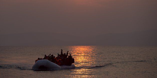 The sun rises as migrants and refugees on a dingy arrive at the shore of the northeastern Greek island of Lesbos, after crossing the Aegean sea from Turkey on Sunday, March 20, 2016. In another incident two Syrian refugees have been found dead on a boat on the first day of the implementation of an agreement between the EU and Turkey on handling the new arrivals. (AP Photo/Petros Giannakouris)
