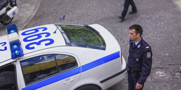 Elevated view of Greek policeman and car