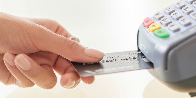 Young woman paying with credit card