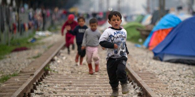 Children run on railway tracks at the northern Greek border point of Idomeni, Greece, Thursday, March 17, 2016. Leaders of the EU's 28 divided nations plan to reconvene in Brussels this week in hopes of ironing out disagreements on a proposed agreement with Turkey in the migrants crisis.(AP Photo/Vadim Ghirda)