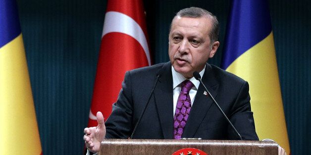 Turkey's President Recep Tayyip Erdogan speaks during a news conference in Ankara, Turkey, Wednesday, March 23, 2016. Erdogan said one of the Brussels attackers was caught in Turkey in June and deported to Belgium. Erdogan says Wednesday that the Belgian authorities released the suspect despite Turkish warnings that he was