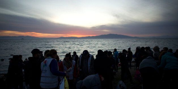 MYTELENE, GREECE - MARCH 12: Refugees from mainly Afghanistan and Syria are seen shortly after arriving on an inflatable boat with other refugees, crossing the sea from Turkey to Lesbos, some 5 kilometres south of the capital of the Island, on March 12, 2016 in Mytelene, Greece. Migrants and refugees are still arriving on the shores of the Island of Lesbos, while the multinational force of the Standing NATO (North Atlantic Treaty Organisation) Maritime Group 2 are patrolling the coast of the Greek Island of Lesbos and the Turkish coast. Turkey announced on Monday to take back illegal migrants in exchange for genuine refugees. (Photo by Alexander Koerner/Getty Images)