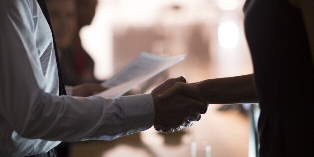 Business people handshaking in conference room