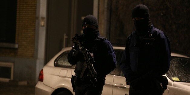 Police officers take part in an operation in Schaerbeek - Schaarbeek, Brussels, late on March 24, 2016. Six people were arrested on March 24, 2016 in a series of police operations in the Belgian capital, the federal prosecutor's office said, two days after jihadist attacks in Brussels left 31 dead. Raids have also taken place in the Brussels district of Schaerbeek where the three airport attackers left from on March 22 morning carrying three explosive-packed suitcases. There have been no arrests in the neighbourhood. / AFP / Belga / NICOLAS MAETERLINCK / Belgium OUT (Photo credit should read NICOLAS MAETERLINCK/AFP/Getty Images)