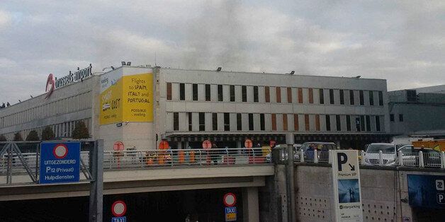 In this image provided by Daniela Schwarzer, smoke is seen at Brussels airport in Brussels, Belgium, after explosions were heard Tuesday, March 22, 2016. (Daniela Schwarzer via AP)