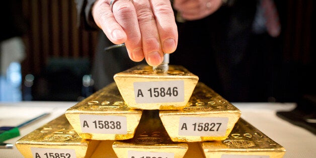 An employee of the German Federal Bank checks the core of a bar of gold during a press conference at the German Federal Bank in Frankfurt am Main, western Germany, on January 16, 2013.The German central Bundesbank said it will relocate parts of its gold stored abroad following recent accusations that it is not keeping proper track of its vast reserves.AFP PHOTO / FRANK RUMPENHORST GERMANY OUT (Photo credit should read FRANK RUMPENHORST/AFP/Getty Images)