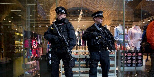 Armed British police officers stand guard after Eurostar services were suspended on the Brussels route because of the attacks in Belgium, at St Pancras international railway station in London, Tuesday, March 22, 2016. Authorities in Europe and beyond have tightened security at airports, on subways, at the borders and on city streets after deadly attacks Tuesday on the Brussels airport and its subway system. (AP Photo/Matt Dunham)