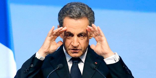 file - In this Sept.27, 2015 file photo, former French President Nicolas Sarkozy reacts during the meeting of Conservative Republicans in Nogent-sur-Marne, outside Paris. French magistrates handed Sarkozy preliminary charges Tuesday Feb.26, 2016 for suspected illegal overspending on his failed 2012 re-election campaign, his latest legal trouble ahead of an expected new presidential bid next year. (AP Photo/Jacques Brinon, File)