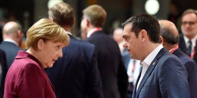 German Chancellor Angela Merkel, left, talks with Greek Prime Minister Alexis Tsipras, right, during the EU summit in Brussels, Belgium on Thursday, Oct. 15, 2015. European Union heads of state meet to discuss, among other issues, the current migration crisis. (AP Photo/Martin Meissner)