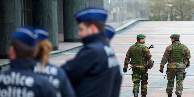 Belgian soldiers patrol outside the European Council headquarters in central Brussels January 21, 2015. Belgium is deploying hundreds of troops and police forces to guard potential targets of terrorism, including Jewish sites and diplomatic missions, following a series of raids and arrests, the defence minister said on Saturday. Up to 300 military will be stationed at locations such as the U.S. and Israeli embassies in Brussels and NATO and EU institutions. REUTERS/Yves Herman (BELGIUMCIVIL