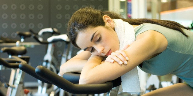 Woman resting on exercise bike