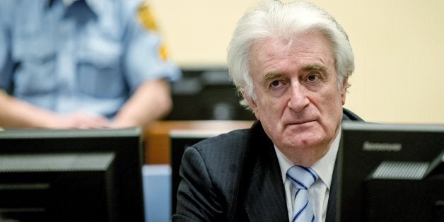 Bosnian Serb wartime leader Radovan Karadzic sits in the courtroom for the reading of his verdict at the International Criminal Tribunal for Former Yugoslavia (ICTY) in The Hague, on March 24, 2016.The former Bosnian-Serbs leader is indicted for genocide, crimes against humanity, and war crimes. / AFP / POOL / Robin van Lonkhuijsen / Netherlands OUT (Photo credit should read ROBIN VAN LONKHUIJSEN/AFP/Getty Images)