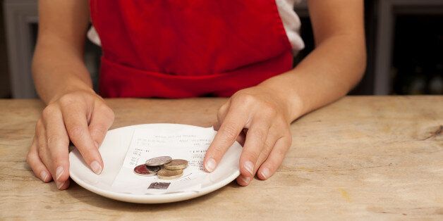 Close up of waitress with bill and gratuity at kitchen counter