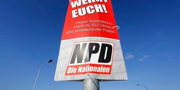 In this Thursday, Feb. 25, 2016 photo a campaigning poster of German nationalist party NPD hangs on a lamp post in Nauen, Germany. The poster reads