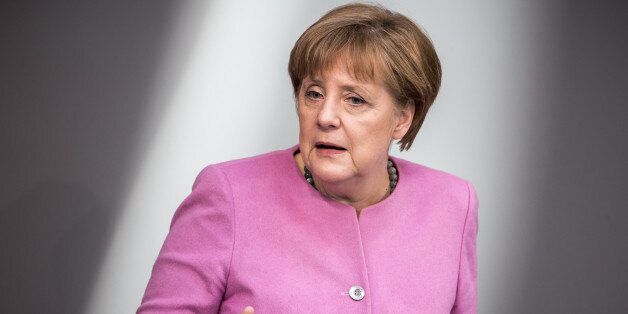 German Chancellor Angela Merkel (C) speaks at the Bundestag (lower house of parliament) on March 16, 2016 in Berlin.Merkel laid out the German position prior to a European Union summit in Brussels on the refugee crisis. A draft EU-Turkey deal to stem the flow of migrants, which was championed by Merkel, has run into resistance from some EU states and legal problems. / AFP / dpa / Michael Kappeler / Germany OUT (Photo credit should read MICHAEL KAPPELER/AFP/Getty Images)