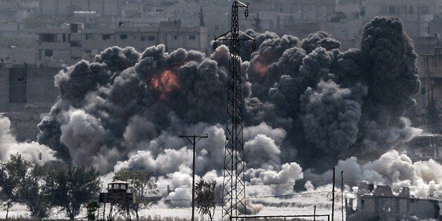 A picture taken from the Turkish border near the southeastern village of Mursitpinar, in the province of Sanliurfa shows smoke billowing after a jet fighter hit Kobane, also known as Ain al-Arab, on October 28, 2014. Turkey wants the anti-Damascus Free Syrian Army (FSA) to control the Syrian border town of Kobane if Islamist jihadists are defeated, and not the forces of separatist Kurds or President Bashar al-Assad, Prime Minister Ahmet Davutoglu said. Turkey is fearful that Kobane could be taken over by Kurds allied to the Kurdistan Workers' Party (PKK) which has waged a three-decade insurgency for self rule and is regarded as a terrorist group by Turkey, the United States and most of Europe.AFP PHOTO/STRINGER (Photo credit should read STR/AFP/Getty Images)
