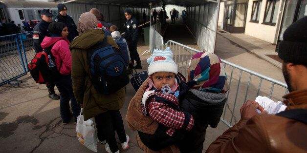 Migrants wait to board a train at the train station in Sid, about 100 km (62 miles) west from Belgrade, Serbia, during U.S. Sen. John McCain, unseen, visit on Friday, Feb. 12, 2016. Sen. McCain and a U.S. Congress delegation pledged assistance to Serbia and other countries along the Balkan migrant route. (AP Photo/Darko Vojinovic)