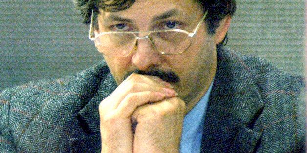 Marc Dutroux looks out from behind protective glass during a court session at the Palace of Justice in Arlon, Belgium, Tuesday June 22, 2004. Belgium's trial of the century nears its close on Tuesday with sentencing expected for the accused later in the day. (AP Photo/Didier Lebrun, Pool)