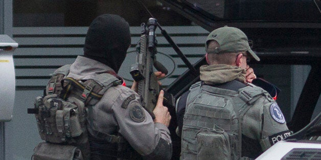 Police secure an area after an apartment raid in Brussels on Tuesday, March 15, 2016. Belgian police launched an anti-terror raid linked to last year's Paris attacks in a Brussels neighborhood on Tuesday. A police official, who requested anonymity because the operation was still ongoing, said the exact circumstances of the incident were still unclear, and that several police officers were injured. (AP Photo/Thierry Monasse)